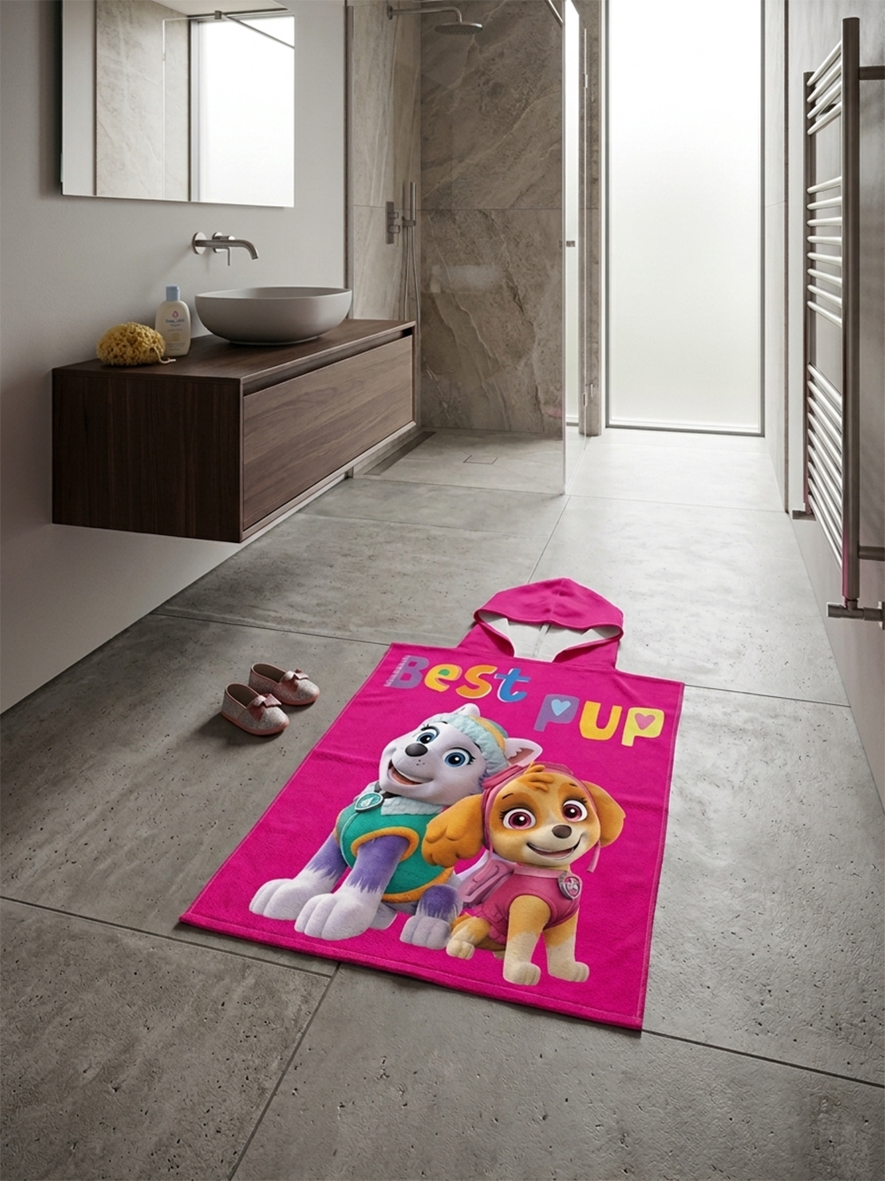 Paw Patrol Girls Badeponcho mit Kapuze 50x100 cm, 100% Baumwolle liegend auf einem Badezimmerboden.