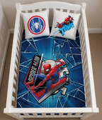Kinderbettwäsche Spiderman Baby Bettwäsche 100x135 cm / 100% Baumwolle in einem Gitterbett. Ansicht von oben auf das Babybett.