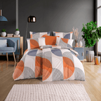 Bett mit geometrischer Bettwäsche in Orange, Grau und Weiß. Kreis‑ und Linienmuster, modernes Zimmer mit dunkler Wand, Pflanzen und Deko.