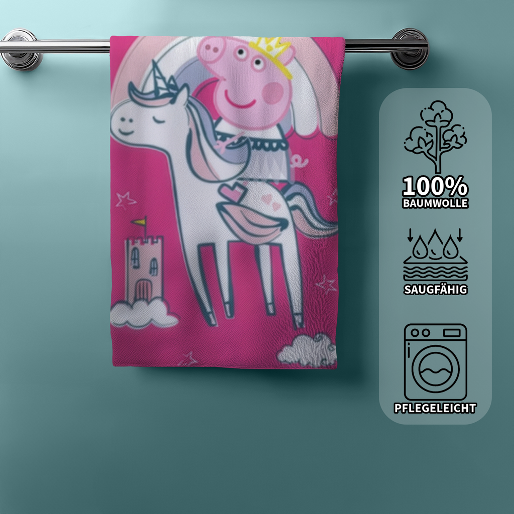 Hängendes Peppa‑Pig‑Handtuch mit Einhorn und Regenbogen. Rechts Icons: 100% Baumwolle, saugfähig, pflegeleicht.