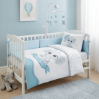 Stimmungsvolle, perspektivische Ambiente-Aufnahme im liebevoll eingerichteten Babyzimmer; zeigt das bezogene Bettchen mit passendem Nestchen, einem Mobile mit blauen Herzen und einem Plüschelefanten auf dem Fußboden.