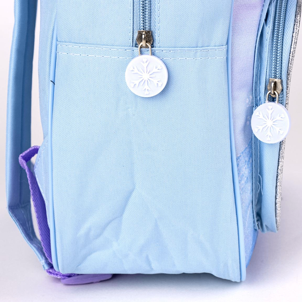 Seitenansicht des hellblauen Rucksacks mit geschlossenen Reißverschlüssen und weißen, runden Zipper-Anhängern aus Gummi in Schneeflocken-Optik.
