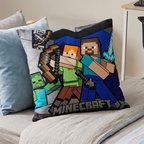 Nahaufnahme der Vorderseite des Minecraft-Kissens mit Steve, Alex und Mobs auf einem Bett.